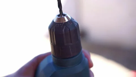 Close up of hand installing drill bit into power drill chuck, DIY hardware tool Stock Footage 345869496