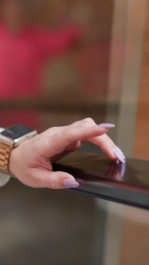 Close up of Hand Interacting with Smartwatch and Electronic Device showing Stock Footage 348238631