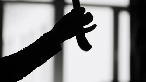 Close-up of a hand with a katana perform exercises on a light background. Media Stock Footage 160894788