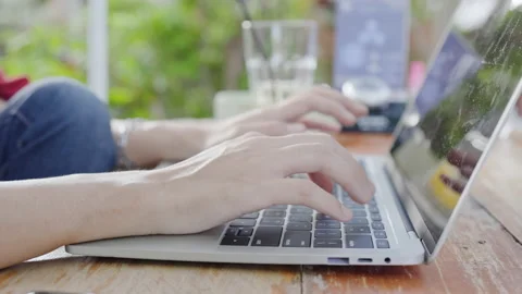 Close up hand key to find information online laptop sits garden studying online Video stock 158040393
