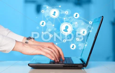 Close up of hand with laptop and social media icons Stock Photos