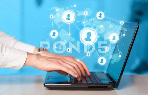 Close up of hand with laptop and social media icons Stock Photos