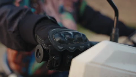 Close-up: Hand in leather gloves grips handlebar, accelerates motorbike outdoors Stock Footage 255294522