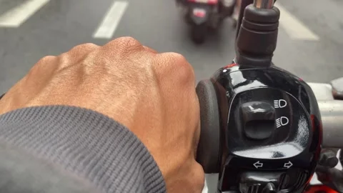 Close up hand on left handle motorcycle on road daytime urban city Stock Footage 248116759