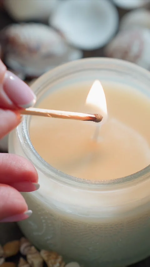 Close up of hand lighting unscented glass jar candle with match steady flame on Stock Footage 344671388