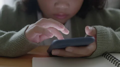 Close up of Hand little girl using smartphone or typing message in the night Stock Footage 154304563