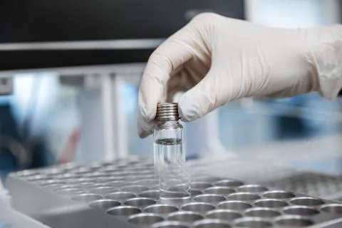 Close-up of hand loading a test tube with DNA samples for polymerase chain Fotos de archivo