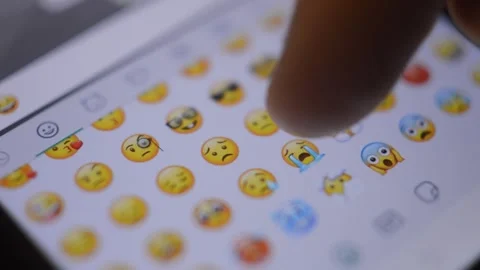 Close-up hand looking for yellow emoticon on his smartphone. Video stock 228908004