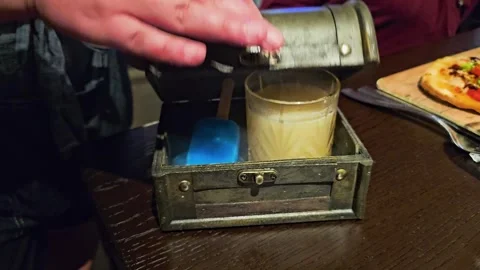 Close-up of a hand lowering the lid of a treasure chest style drink box Stock Footage 343720853