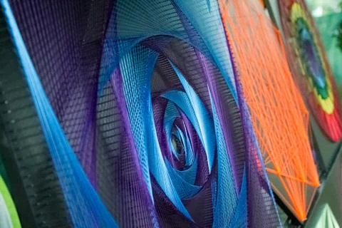 Close-up of a hand-made article made of multi-colored threads stretched over  Stock Illustration