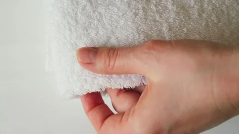 A close-up of a hand of maid arranging and smoothing white towels. The scene Stock Footage 334713181
