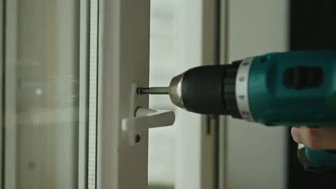 Close-up hand of maintenance professional using cordless screwdriver, tightening Stock Footage 311053535