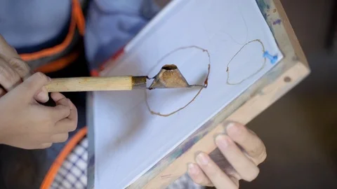 Close up of hand making batik pattern Stock Footage 107802065