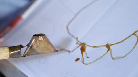 Close up of hand making batik pattern Stock Footage 107802173