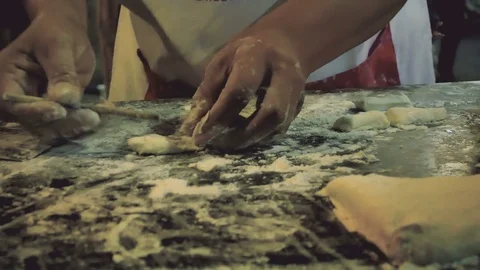 Close up hand Making Deep fried dough stick at night street food in Thailand Stock Footage 77533637