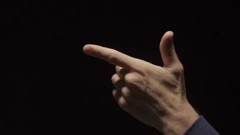 Close up of a hand making handgun gesture fires in the air three times and exits Stock Footage 132260481