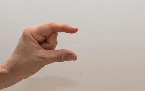 Close-up of a hand making a precise pinching gesture, mimicking the act of .. Foto stock