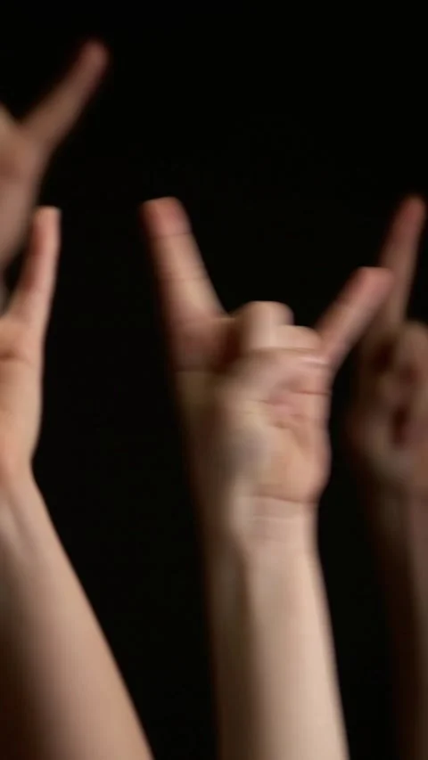 Close-up of hand making rock horns gesture at concert or music festival against Vídeo Stock 347461012