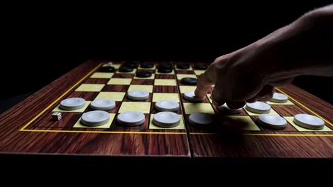 Close-up of a Hand Making a Strategic Move on a Checkerboard, Planning the Next  库存影片 330434926