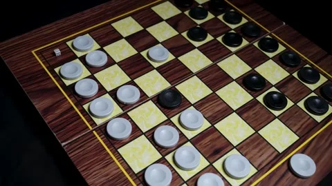 Close-up of a Hand Making a Strategic Move on a Checkerboard, Planning the Next  Видео 330435053