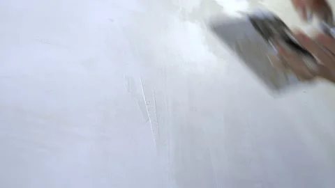Close-up of a hand. a man applies plaster with a trowel to the wall Stock-Footage 143028645