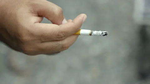 Close up hand man holding a cigarette. He going to smoke. world tobacco day Stock Footage 153928610
