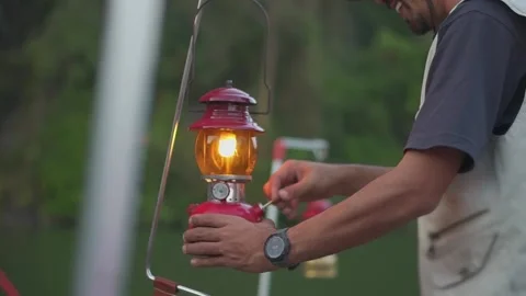 Close up hand of A man lanterns are lit lantern for light. Stock Footage 234975116
