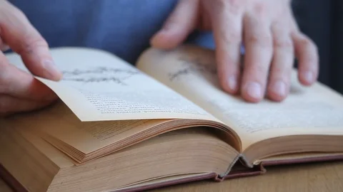 Close-up of a hand of man leafing through a book Stock Footage 109461561