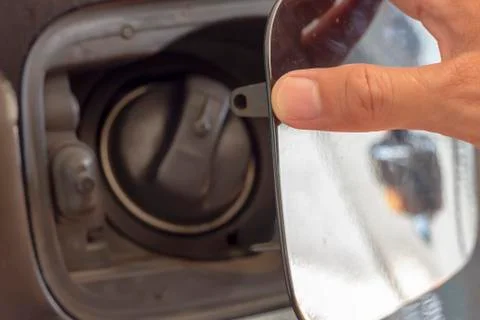 Close up hand man open the fuel tank cover in the car Stock Photos