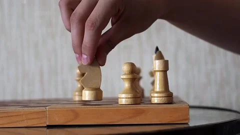 Close-up of the hand of a man playing chess, making move by knight in a chess Stock Footage 236459855