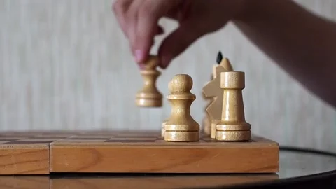Close-up of the hand of a man playing chess, making move by pawn in a chess Video stock 236459873