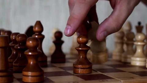 Close-up of the hand of a man playing chess, making move by knight in a chess Video stock 236459903