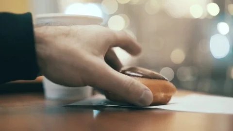 Close up of hand of man taking a donut Видео 74276122
