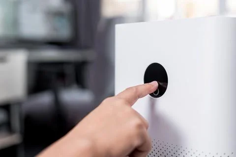 Close up hand a man touching screen monitor of Air purifier for start air f.. 写真素材