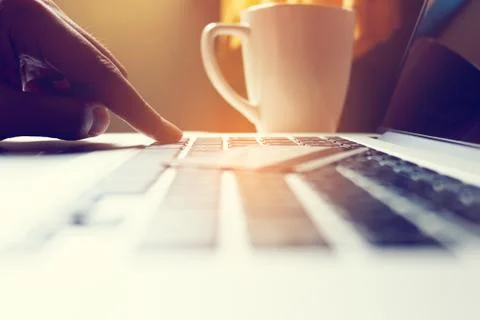 Close up hand man typing on keyboard laptop with shopping online. Stock Photos