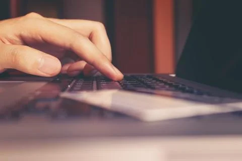 Close up of hand man typing keyboard computer laptop and credit card with s.. Stock Photos