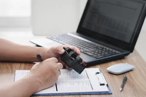 Close up hand a man use a pen check part detail number on checklist with sw.. Stock-Fotos