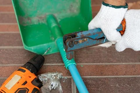 Close-up hand of man use rivet gun or rivet pliers to repair the plastic du.. Stock Photos
