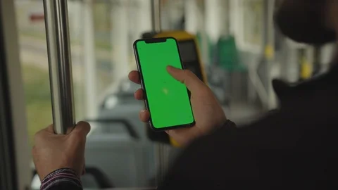 Close up hand man uses holding a mobile phone with a vertical green screen Stock Footage 117942895