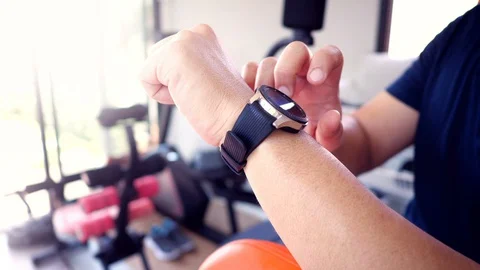Close up hand of a Man using and making gestures on a wearable smart watch Stock Footage 127614174