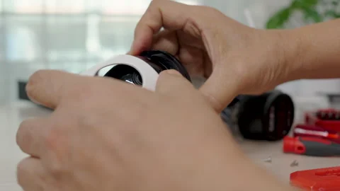 Close-up hand of man using screwdriver to repairing a wireless CCTV camera. Stock Footage 326299274