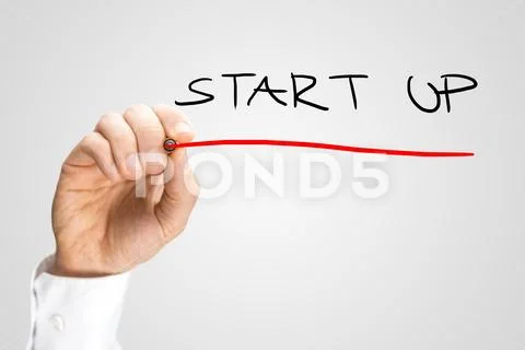 Close up of the hand of a man writing Start up Stock Photos