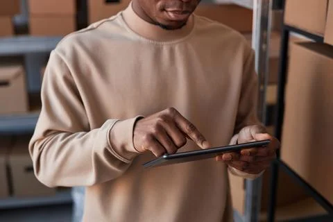 Close-up of hand of manager pointing at tablet screen while entering data Stock Photos