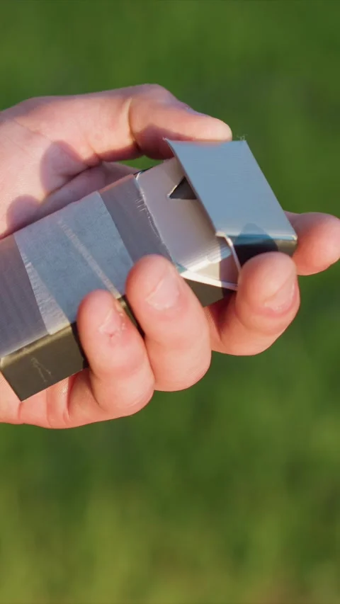 Close up of hand manipulating improvised duct tape and metal box revealing Stock Footage 345079881