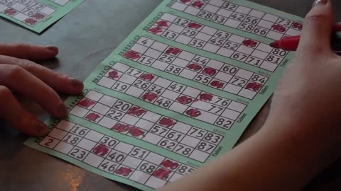 Close Up Hand Marking Bingo Card Video stock 142549422