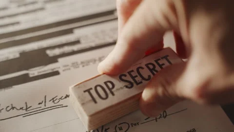 Close up hand marks classified document as Top Secret with red ink rubber stamp Stock-Footage 242424292
