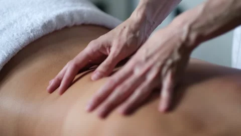 Close up Hand of masseuse doing massage back with aromatherapy oil on back of a Stock Footage 282082809