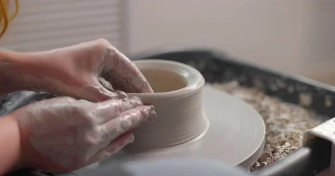 Close-up of the hand of a master potter working on a potter's wheel, forming a Stock Footage 155628558