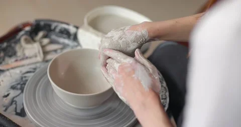Close-up of the hand of a master potter working on a potter's wheel, forming a Stock Footage 155628665