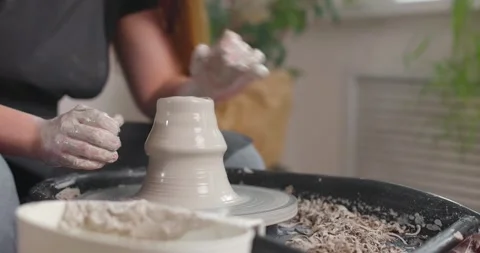 Close-up of the hand of a master potter working on a potter's wheel. Slow motion Stock Footage 155942069